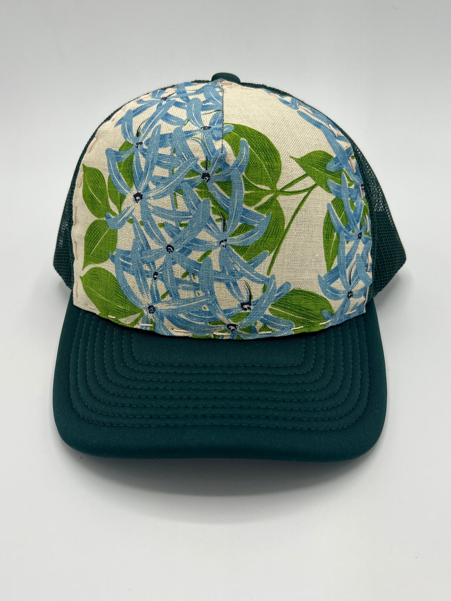 Bagshaws of Saint Lucia vibrant vintage lupine fabric- forest green curved brim trucker hat