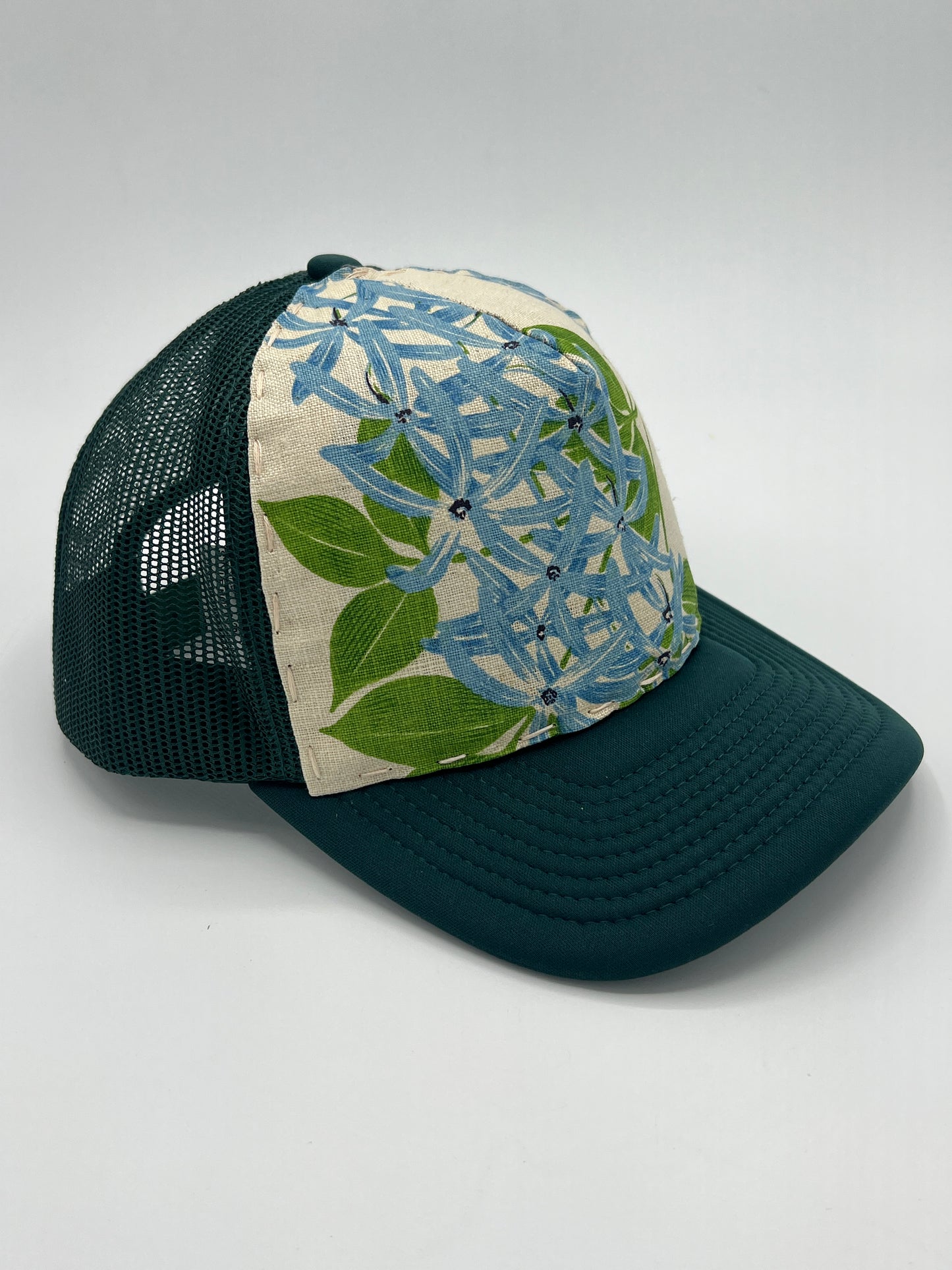 Bagshaws of Saint Lucia vibrant vintage lupine fabric- forest green curved brim trucker hat