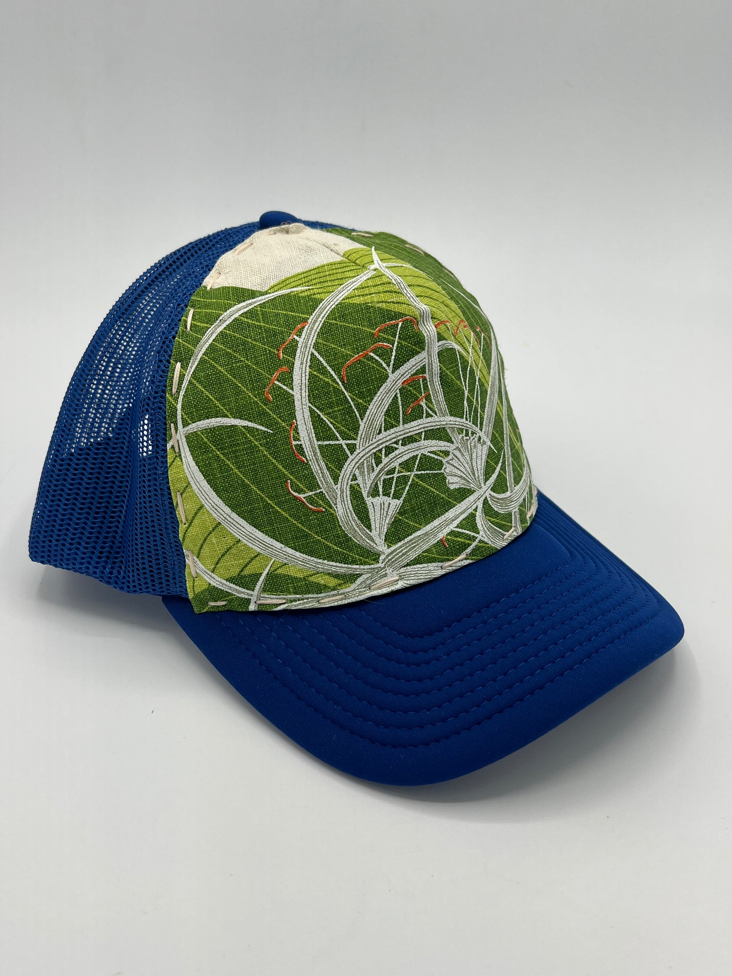 Bagshaws of Saint Lucia vibrant vintage spider lily fabric- blue curved brim trucker hat