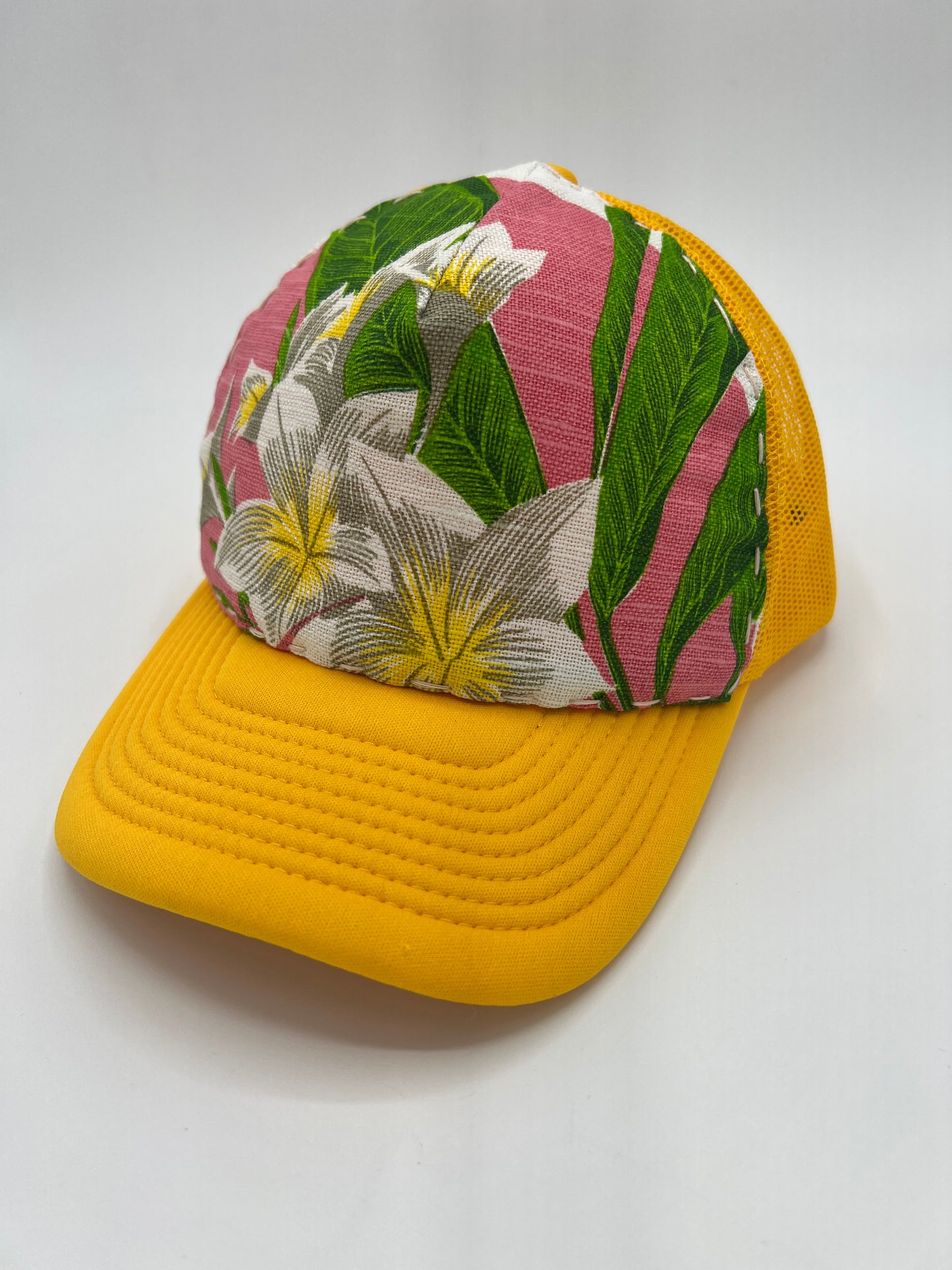 Bagshaws of Saint Lucia vibrant plumeria vintage fabric- yellow curved brim trucker hat