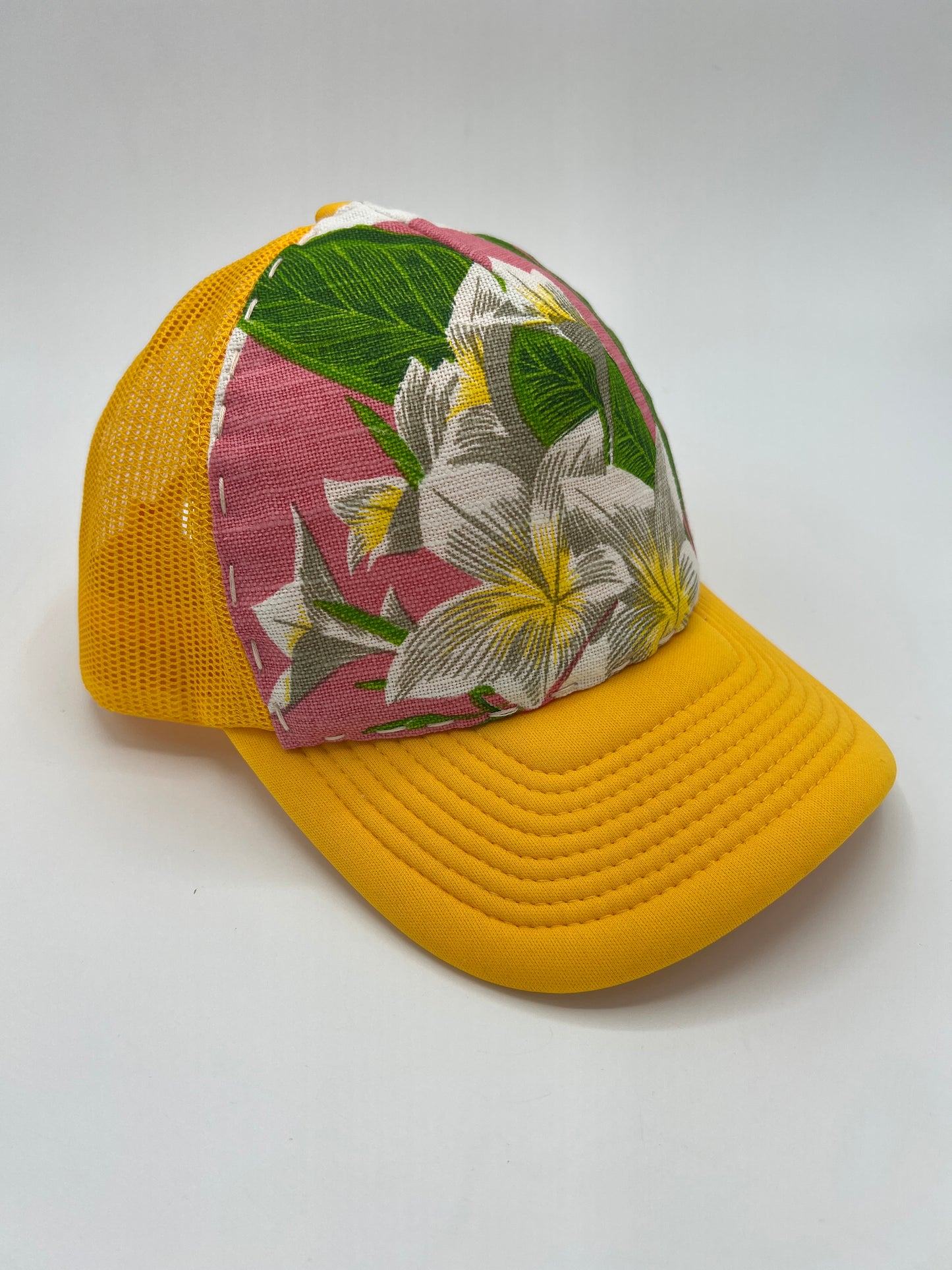 Bagshaws of Saint Lucia vibrant plumeria vintage fabric- yellow curved brim trucker hat