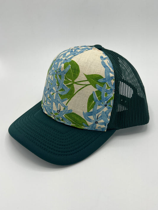 Bagshaws of Saint Lucia vibrant vintage lupine fabric- forest green curved brim trucker hat