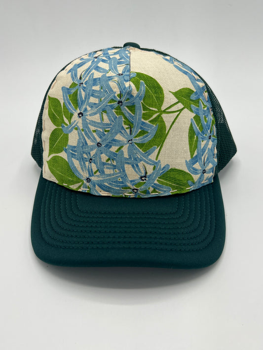Bagshaws of Saint Lucia vibrant vintage lupine fabric- forest green curved brim trucker hat