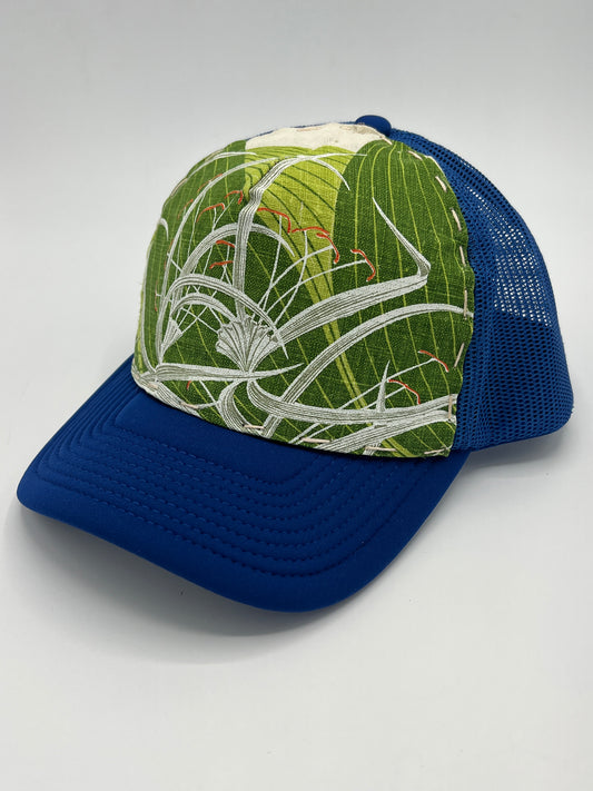 Bagshaws of Saint Lucia vibrant vintage spider lily fabric- blue curved brim trucker hat